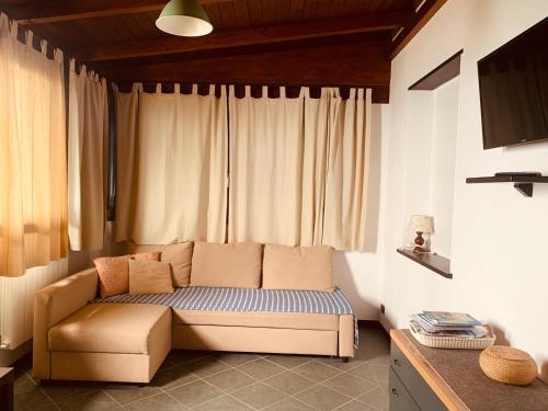 a living room with a couch in front of a window at Tramonto sul Mare in Framura
