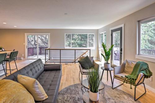 a living room with a couch and a table at Scenic Conifer Getaway with Game Room and Hot Tub! in Conifer
