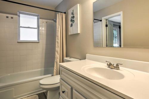a bathroom with a sink and a toilet and a mirror at Scenic Conifer Getaway with Game Room and Hot Tub! in Conifer