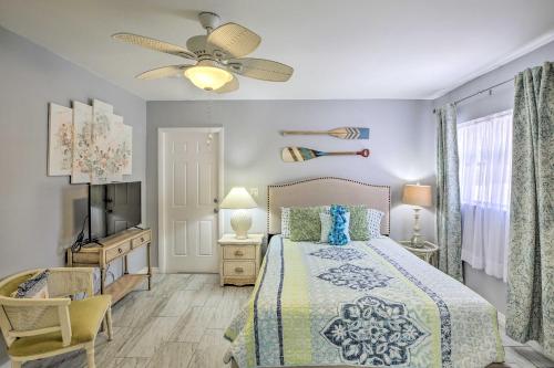 a bedroom with a bed and a ceiling fan at Heated Pool and Lanai Matlacha Isles Getaway in Matlacha