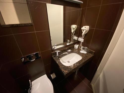 a bathroom with a sink and a toilet at Villa Joma in Jūrmala