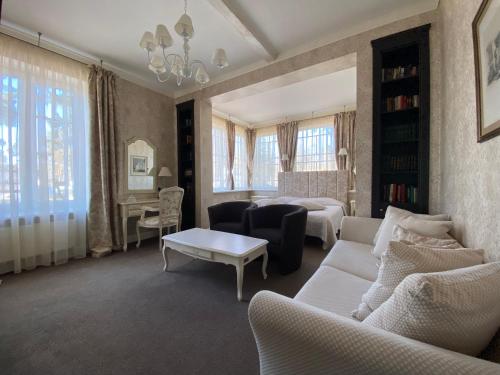 a living room with a couch and a table at Villa Joma in Jūrmala