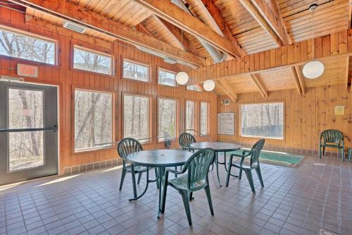 a dining room with tables and chairs and windows at Lincoln Station Escape - Walk to Restaurants! in Lincoln