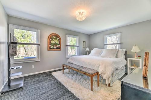 a bedroom with a bed and two windows at Pittsford Trolley Home - Near Erie Canal! in Pittsford