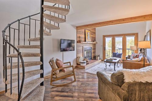 a living room with a spiral staircase and a fireplace at Private Balcony and Resort Perks Silverthorne Condo in Silverthorne