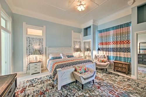 a bedroom with a bed and a chair in a room at Renovated Carnegie Cottage - Walk to Dtwn! in Winnsboro