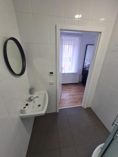 a bathroom with a sink and a mirror at B&B Hotel Telsiai in Telšiai