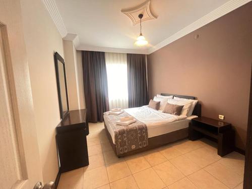 a bedroom with a bed and a window at City Inn Family Apart in Antalya