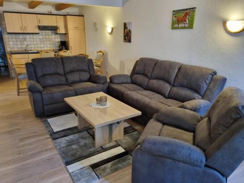 ein Wohnzimmer mit 2 Sofas und einem Couchtisch in der Unterkunft Ferienhof-Stoertebeker in Leybuchtpolder