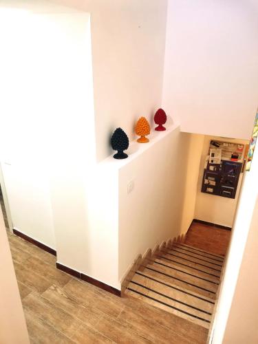 a hallway with two vases sitting on the stairs at A due passi dal centro Sweet Rooms in Agrigento