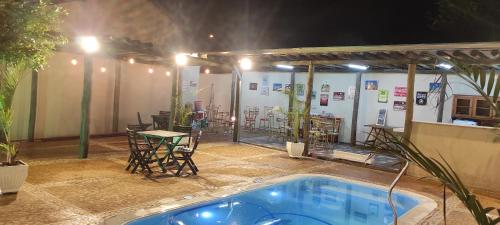 a patio with a table and a swimming pool at Belo Quinto Styles in Brotas
