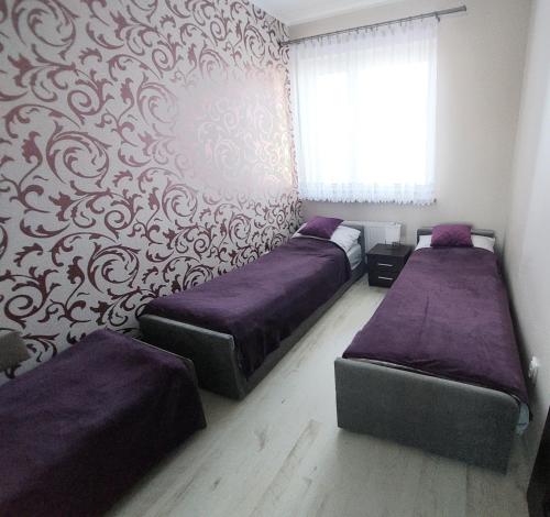 Posteľ alebo postele v izbe v ubytovaní Apartament Zdrojowy Jastrzębia Góra
