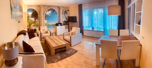 a living room with a table and a dining room at CariSSA AparthotelFerienwohnung in Bad Bevensen