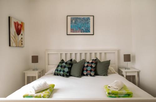 a bedroom with a white bed with pillows on it at Casa de Marina in San Miguel de Abona