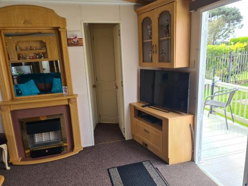 a living room with a tv and a fireplace at 6 Berth on Seaview (Topaz) in Ingoldmells
