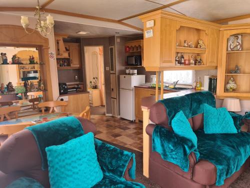 a living room with two couches and a kitchen at 6 Berth on Seaview (Topaz) in Ingoldmells