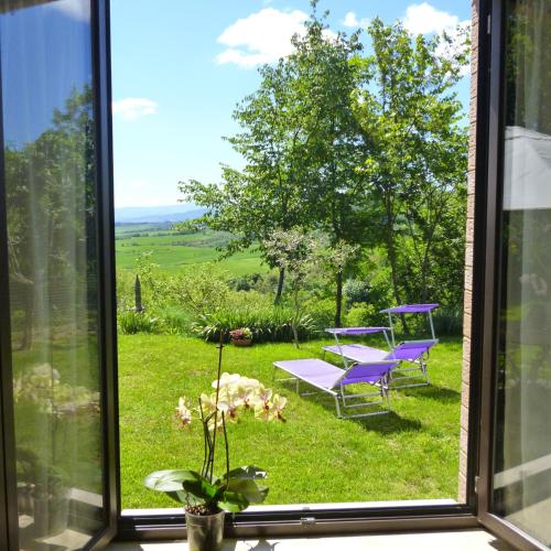 a window with a view of a table and a bench at Villa Righino in Murlo