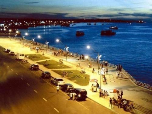 a group of people standing on a pier near the water at Casa Cantinho de Santarém in Santarém