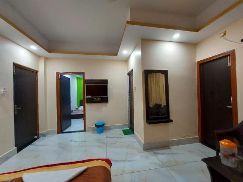 a living room with a large room with a mirror at ICONIC Hotel Digha in Digha