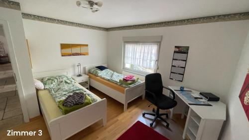 a small room with a bed and a desk at Wohnen im bergischen Fachwerk in Overath