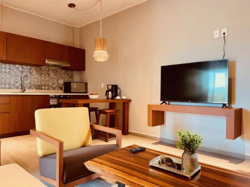 a living room with a large flat screen tv at Hotel Manglar Suites in Mahahual