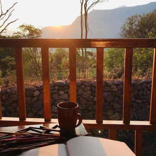 a coffee cup sitting on a table on a balcony at Unuwasi Hotel & Villa in Calca