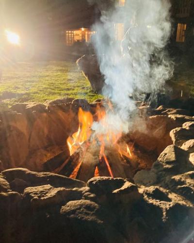 a fire with smoke coming out of the rocks at Unuwasi Hotel & Villa in Calca