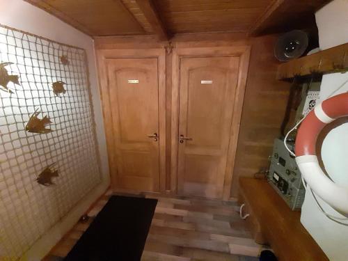 a room with two wooden doors in a kitchen at Yacht Club in Liepāja