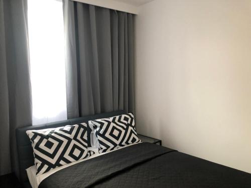 a bedroom with a bed with a pillow and a window at Apartamenty Platinex 6 in Krakow