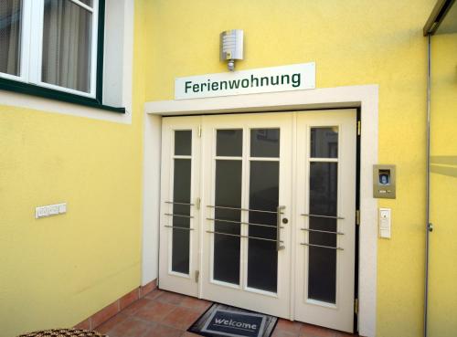 a front door of a building with a sign above it at Ferienappartement Regina in Schrems