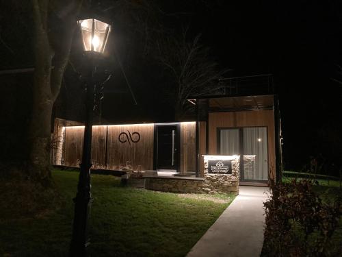 a street light in front of a house at night at Tiny House - Luxury Cottage in Bullange