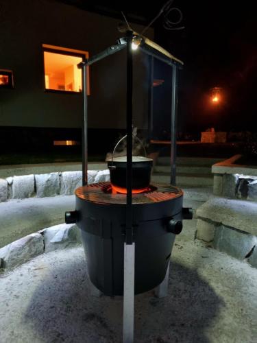 a pot sitting on top of a stove in a yard at Vila Park Ravne in Ravne na Koroškem