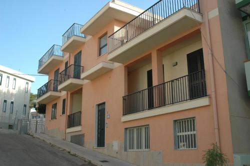 a building with balconies on the side of a street at Casa Vacanze Antares in Portopalo