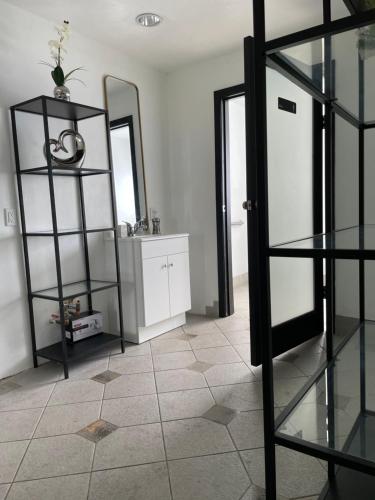 a room with a mirror and a sink and a shelf at Culver City Hostel in Los Angeles