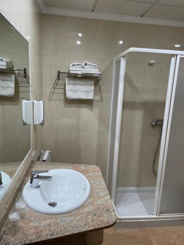 a bathroom with a sink and a shower at HOTEL MORENO in Elche de la Sierra