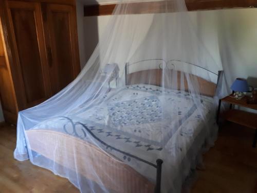 a bedroom with a bed with a mosquito net at Lou Cabanis in Saint-Germain-de-Calberte