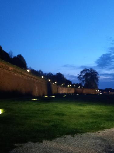 a wall with lights in a field at night at BnB Villa Melany vicino Centro in Lucca
