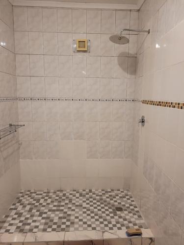 a bathroom with a shower with a black and white at Jacmo Guest Private Rooms in Cape Town