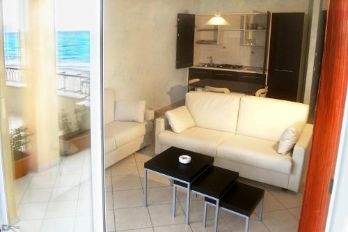 a living room with a couch and a table at Residence Sole in Albenga
