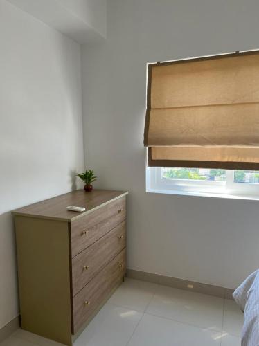 a bedroom with a dresser and a window at Fairway 2 Bedroom Luxury Apartment with Gym and Pool in Battaramulla