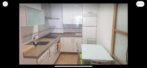 a kitchen with white cabinets and a white counter top at OKTHEWAY MALPICA in Malpica