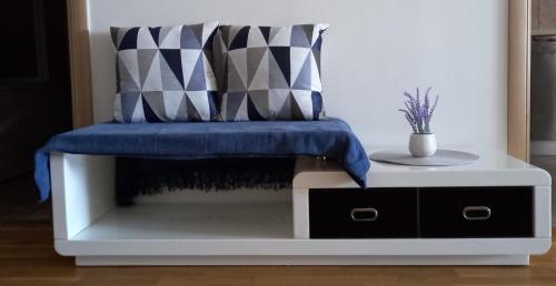 a bench with a blue blanket on top of it at Marys Home Apartment Međugorje in Međugorje