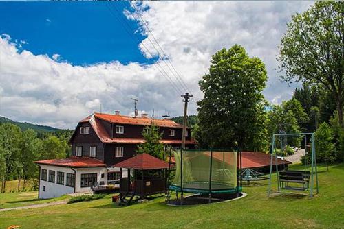 a house with a soccer field in front of a house at Chata Orlice in Bartošovice v Orlických Horách