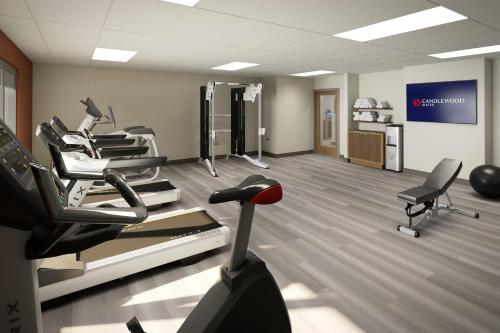 a gym with treadmills and chairs in a room at Candlewood Suites - Columbia by IHG in Columbia