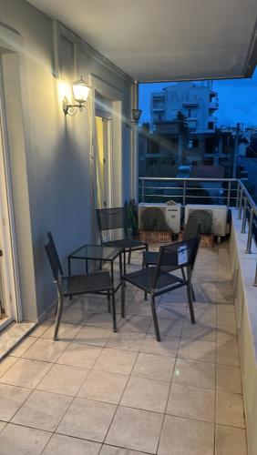 a patio with chairs and a table on a balcony at Christos in Rafina