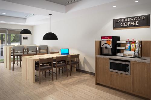 a kitchen and dining room with a table and chairs at Candlewood Suites - Columbia by IHG in Columbia