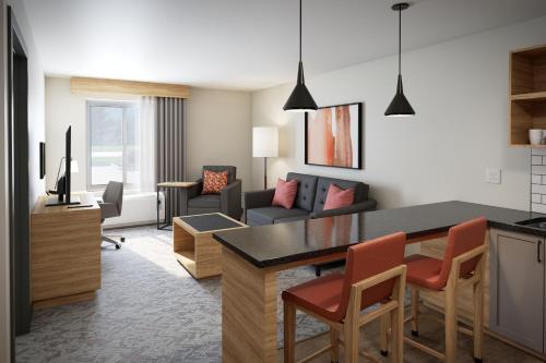 a living room with a kitchen and a living room with a couch at Candlewood Suites - Columbia by IHG in Columbia