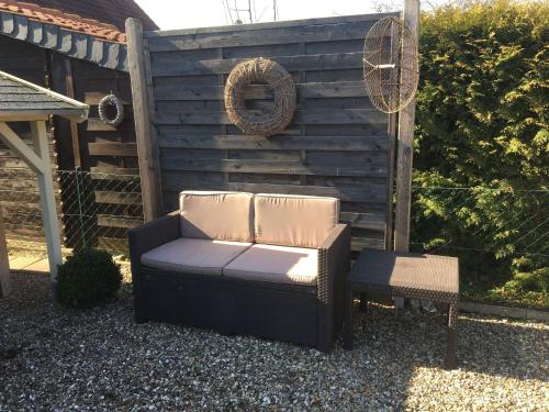 a chair and a stool sitting in a yard at Baltic Hus Zierow s Gem in Zierow