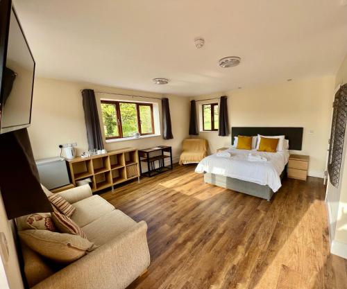 a living room filled with furniture and a large window at Lillypool Farm in Shipham