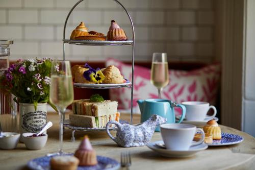 a table topped with pastries and glasses of wine at Room Mate Lime Tree in London